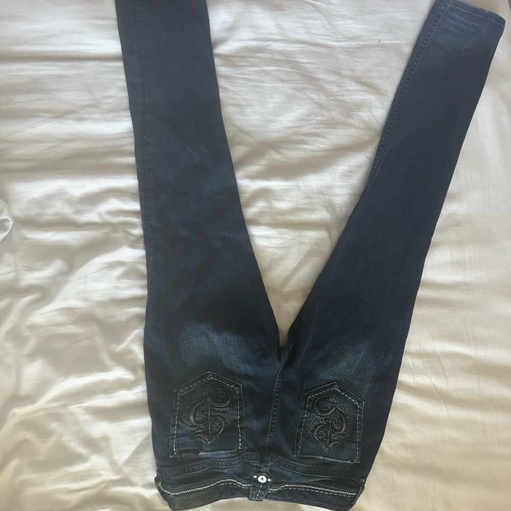 Dark denim, low waisted embroidered jeans.
